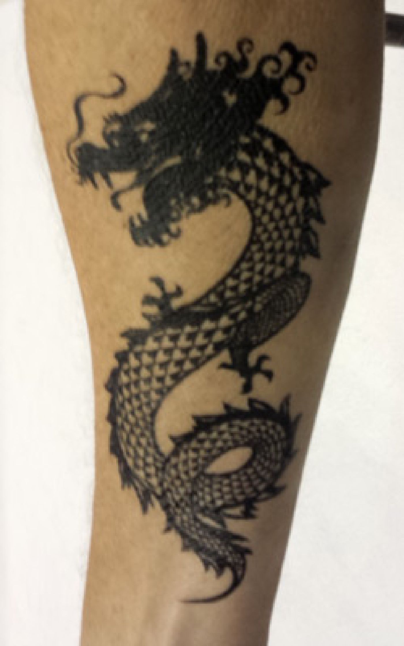 Black matte dragon tattoo, is it real or not? Raleigh NC
