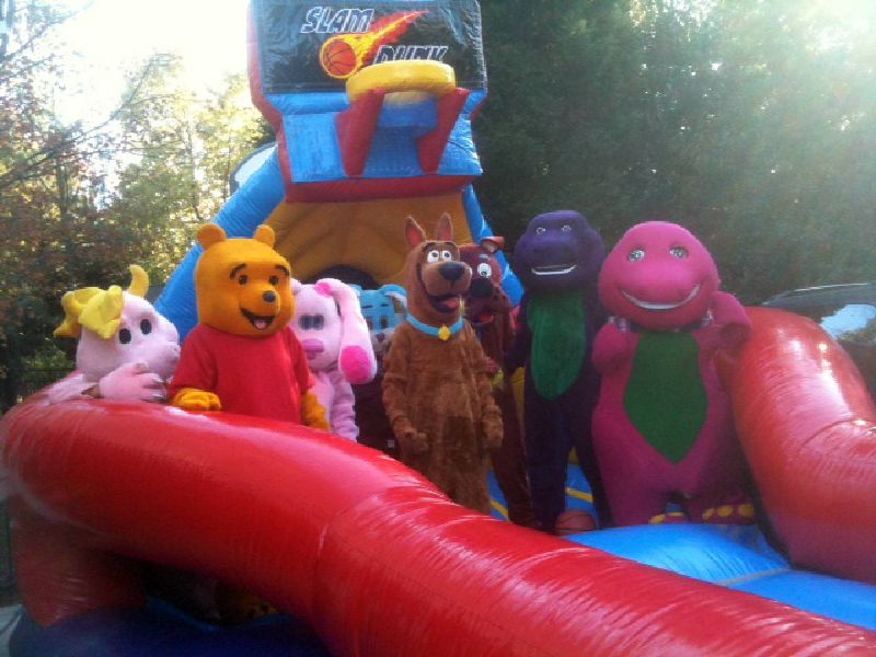 Costumed characters on a bounce house in Cary