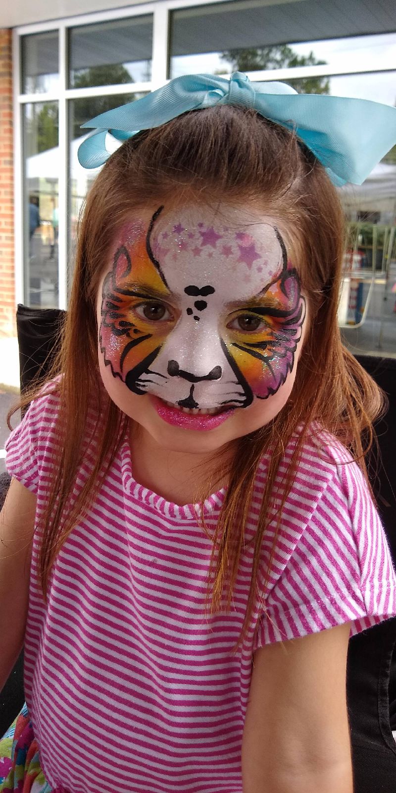 A pretty star, tiger face paint design by Zoe done in Cary NC